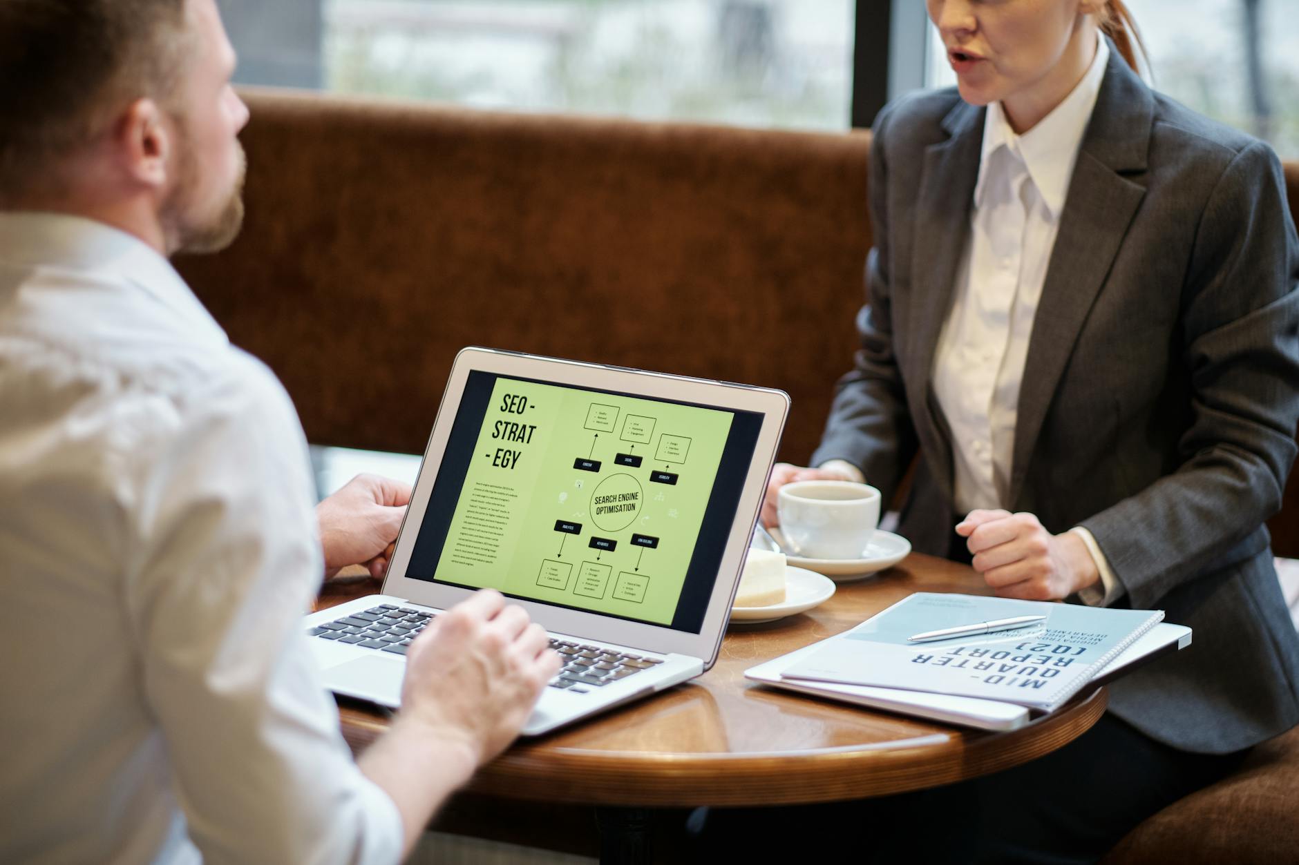 Australian small business owners discussing local SEO strategy over coffee in casual meeting environment