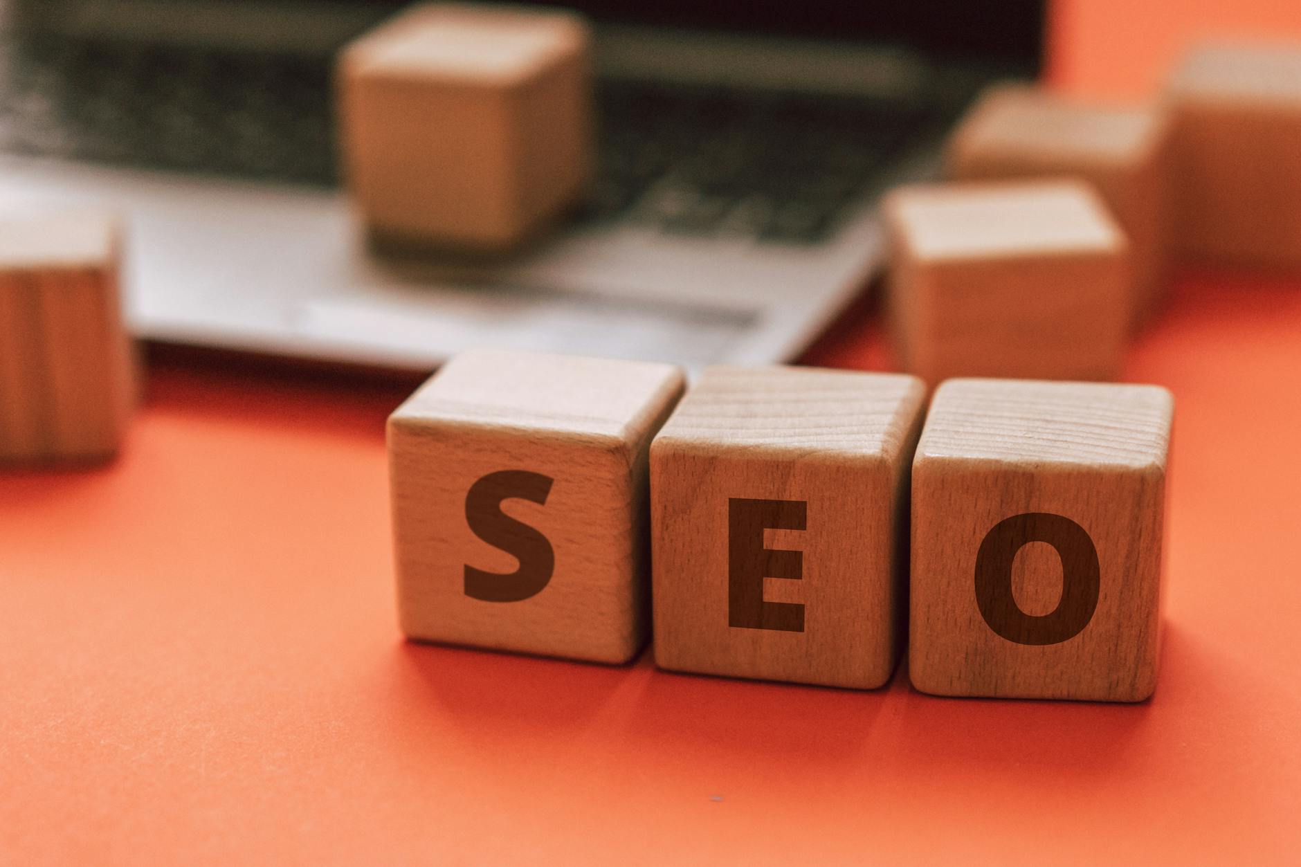 Laptop keyboard with wooden SEO blocks illustrating website performance optimisation for Australian small business growth