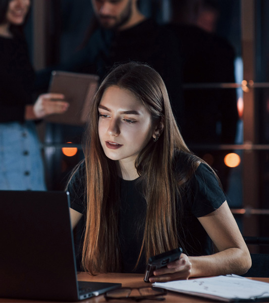 Young woman working on laptop representing website design services for small businesses